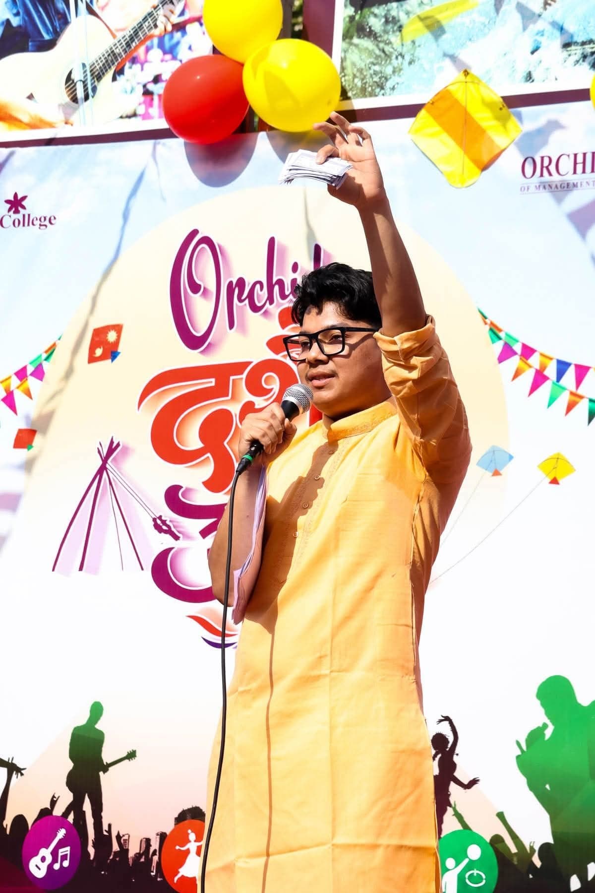 Abinash on stage with a microphone, hosting Orchid Dashain Utsav 2083
